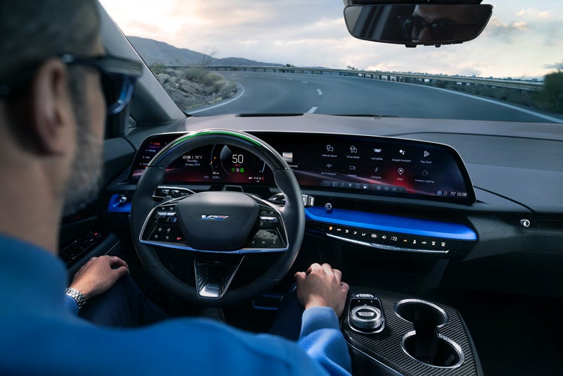 Front View of the 2026 OPTIQ-V Driving Through the Dusk Utilizing its Headlights | Springfield GMC in N. Springfield VT